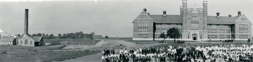 Partial Panorama image of the faculty, staff and students at Northwest with the Administration Building and Powerhouse in the background.  Included alumni from the first graduating class.