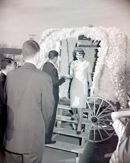 The Tower Queen descends from her carriage to help kick-off the start of the 1962 Homecoming Football Game at Northwest.