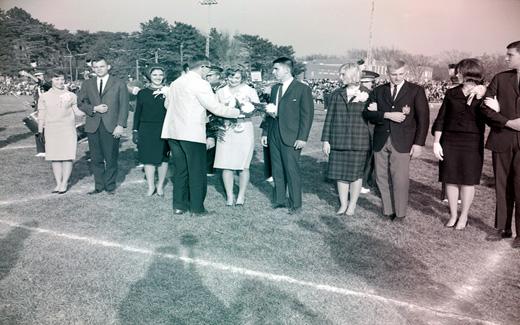 The 1962 Tower Homecoming Queen and Royal Court receive bouquets and corsages prior to start of the Homecoming Football Game.