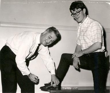 President 福斯特 shines a student's shoes during the early 1960s during Parents' Day Activities.