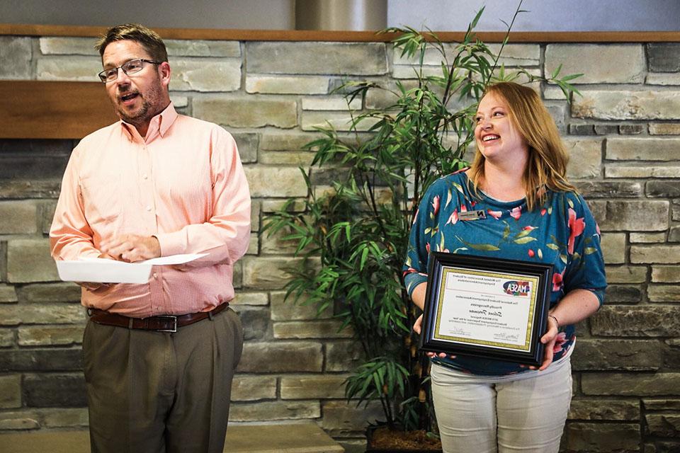 Selena Foreman, left, reacts Monday afternoon as Dr. Matt Baker, Northwest's vice president of student affairs, announces she is the recipient of state and regional Student Employment Supervisor of the Year awards. (Photo by Todd Weddle/Northwest Missouri State University)