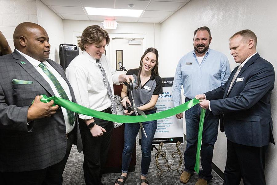 Left to right are Dr. Terry Long, Corey Strider, Elizabeth Motazedi, Dawson Parks and Dr. Clarence Green as they cut a ribbon Thursday celebrating the completion of a third-floor renovation of Martindale Hall. (Photos by Lauren Adams/Northwest Missouri State University)